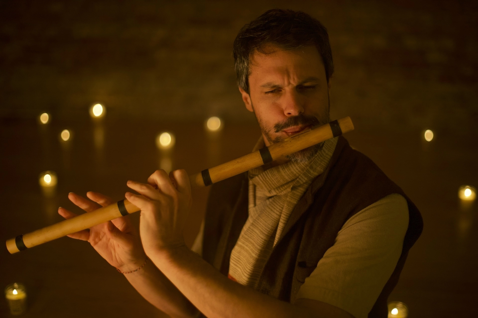 Joshua Geisler playing bansuri by candlelight